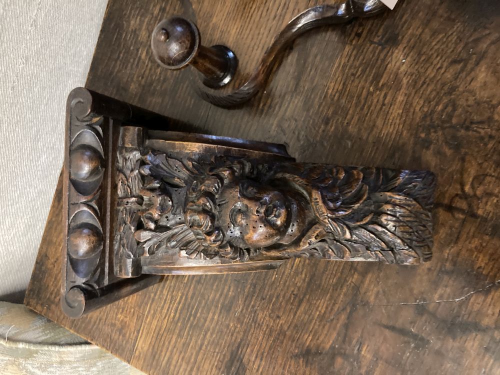 A carved oak eagle hanging coat rack, width 60cm, together with a carved walnut corbel, height 26cm